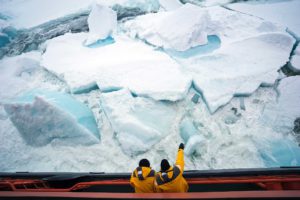 Photo of sea ice with people on ship